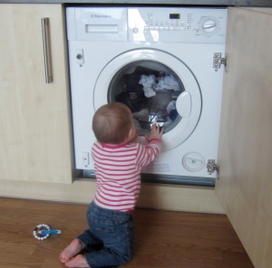 Little L is fascinated by our combo washer/dryer.